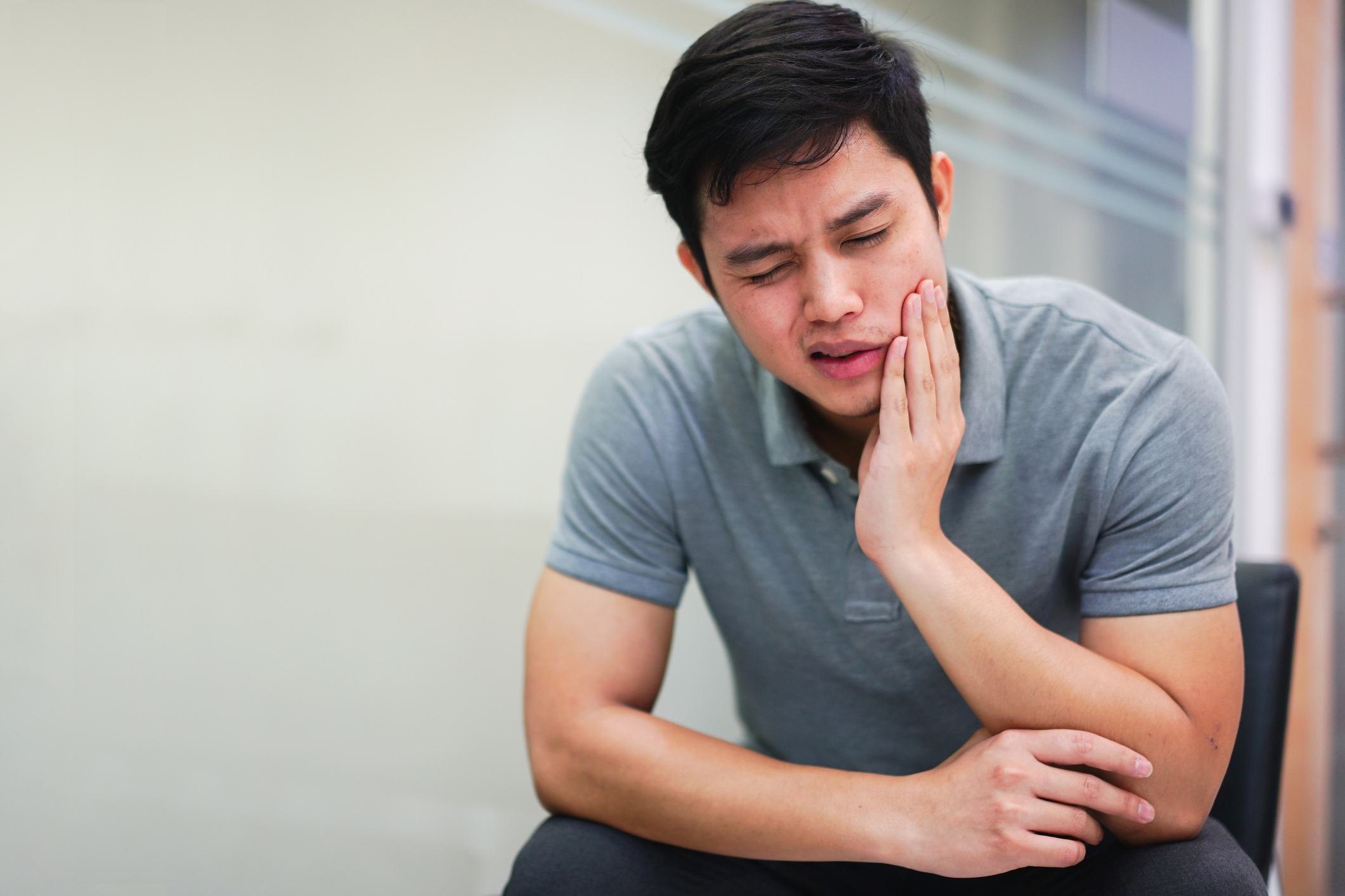 Man with tootache rubs jaw